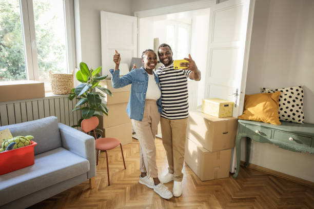 istock Young Couple with boxes Moving  in New Home 1565819979