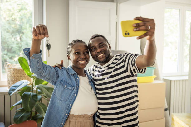 istock Young Couple with boxes Moving  in New Home 1565819982