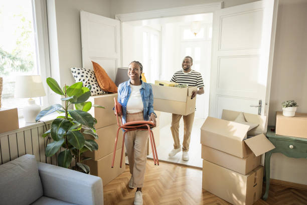 istock Young Couple with boxes Moving  in New Home 1565821086