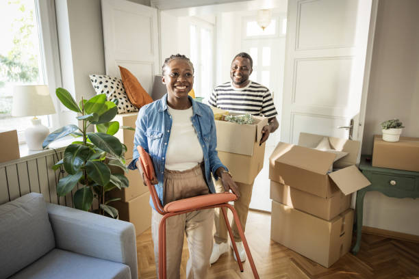 istock Young Couple with boxes Moving  in New Home 1565821088