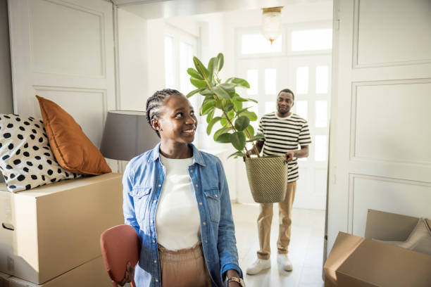 istock Young Couple with boxes Moving  in New Home 1565821632