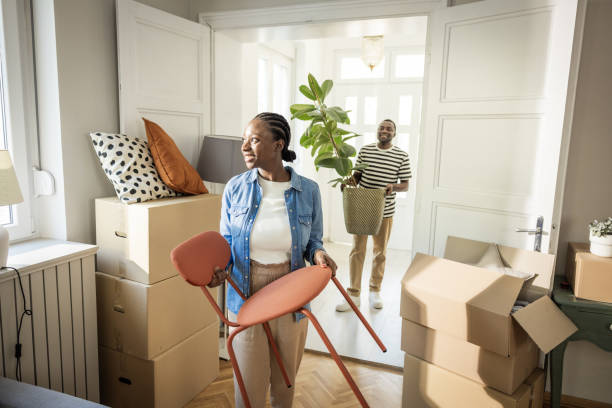 istock Young Couple with boxes Moving  in New Home 1565821633