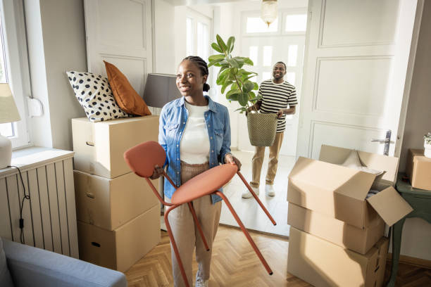 istock Young Couple with boxes Moving  in New Home 1565821654