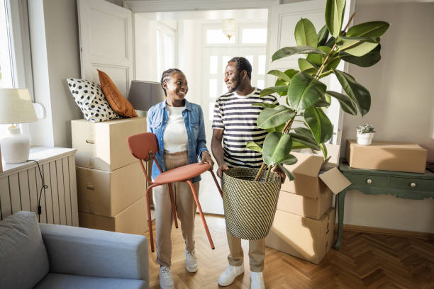 istock Young Couple with boxes Moving  in New Home 1565822170