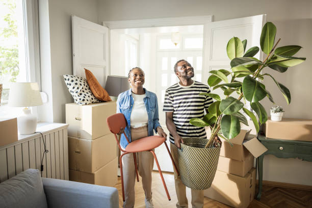 istock Young Couple with boxes Moving  in New Home 1565822216