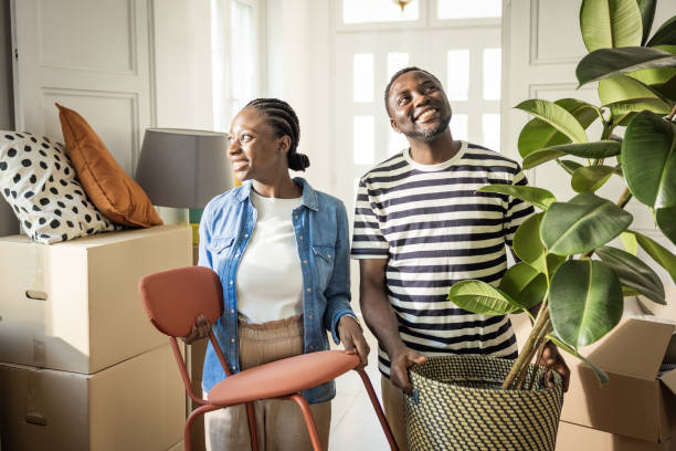 istock Young Couple with boxes Moving  in New Home 1565822751