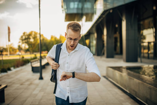 istock A young handsome businessman is late for work 1565823938