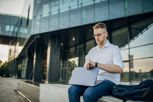 istock A young handsome businessman preparing for working outside 1565834299