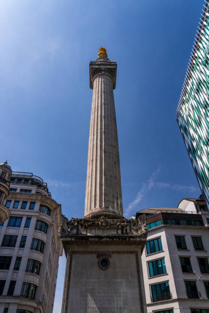 istock Modern office buildings surround the Monument in London 1565863500