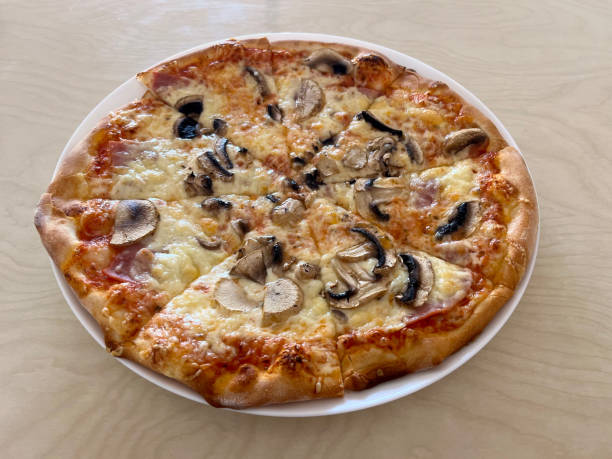 istock Pizza Capriciosa on a plate close-up on the table 1565866075