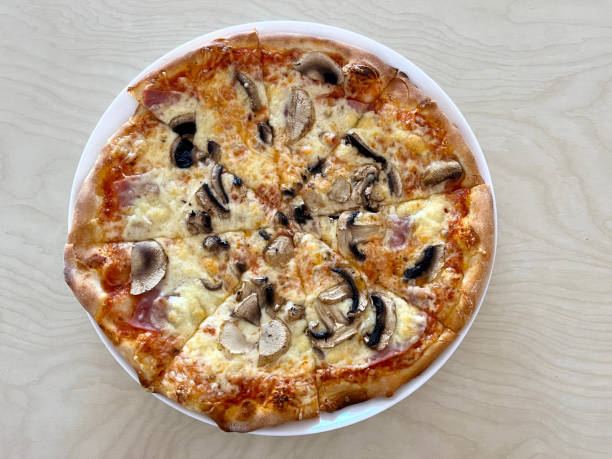 istock Pizza Capriciosa on a plate close-up on the table 1565866077