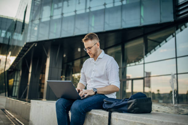 istock Young handsome businessman working outside 1565878362