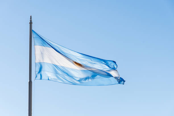 istock Argentine flag on a mast fluttering in the sky. 1565902635