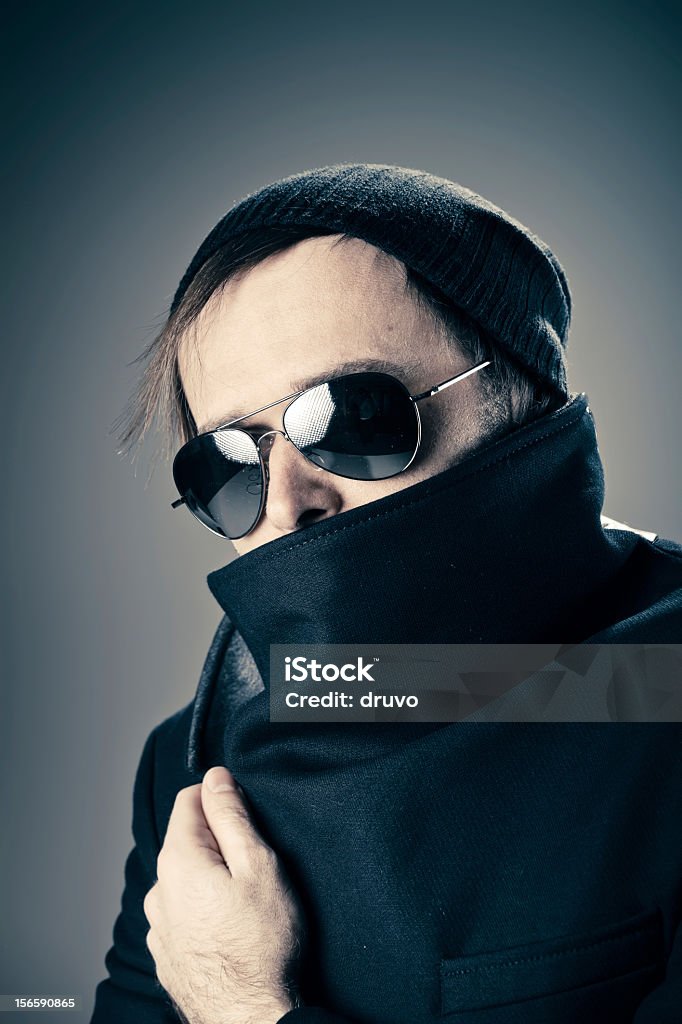Young male hiding behind his coat 25-29 Years Stock Photo