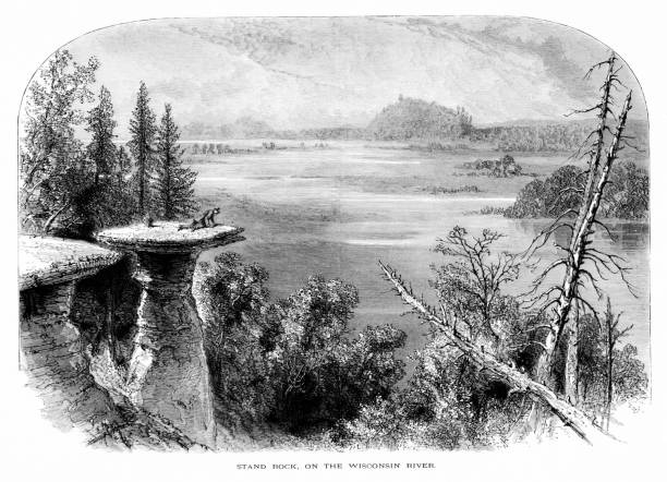 Wisconsin River Stand Rock, Wisconsin, United States, American Geography A man on top of Stand Rock by the Wisconsin River, which flows on the border of Wisconsin and Michigan, USA.  Pencil and pen, engraving published 1874. This edition edited by William Cullen Bryant is in my private collection. Copyright is in public domain. the dalles stock illustrations