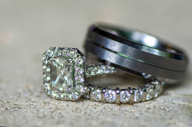 istock Groom & bride wedding rings platinum diamond 1565915052