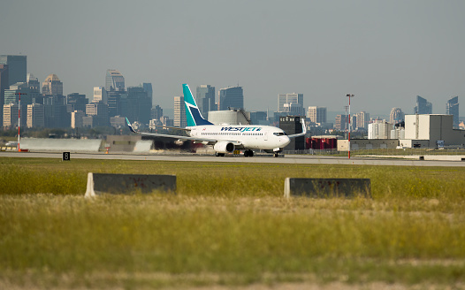 July 22, 2023. Calgary, Alberta, Canada. A WestJet Airlines Boeing 737-700, with identification C-GGWJ, taking off from Calgary International Airport
