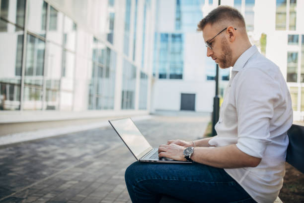 istock Young handsome businessman working outside 1565928276