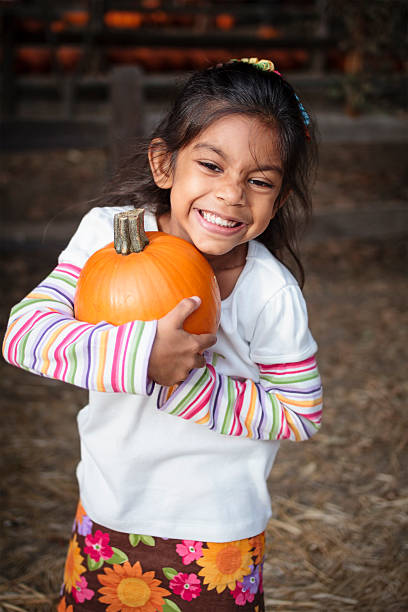 istock Happy girl embracing a pumpkin 156593220