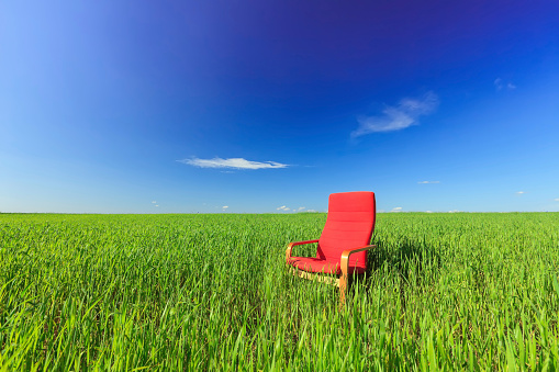 Empty seat in a green field