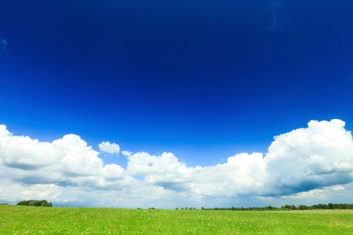 Sunny day with blue sky and some clouds, feeling of tranquility and relaxation, horizontal image