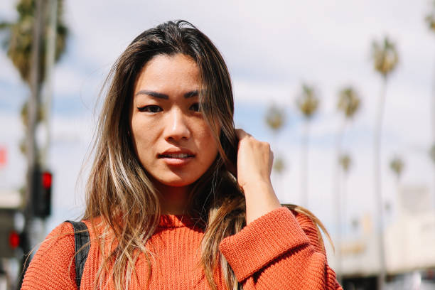 Stylish Asian - American woman walking on the streets of Los Angeles, California, in Van Nuys area of the Valley.