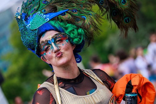 Berlin, Germany July 23 2023: A human in a dress dances at the Christopher Street Day. The Berlin Pride Celebration is a pride parade  to celebrate the lesbian, gay, bisexual, transgender and queer (LGBTQ+) people and their allies.