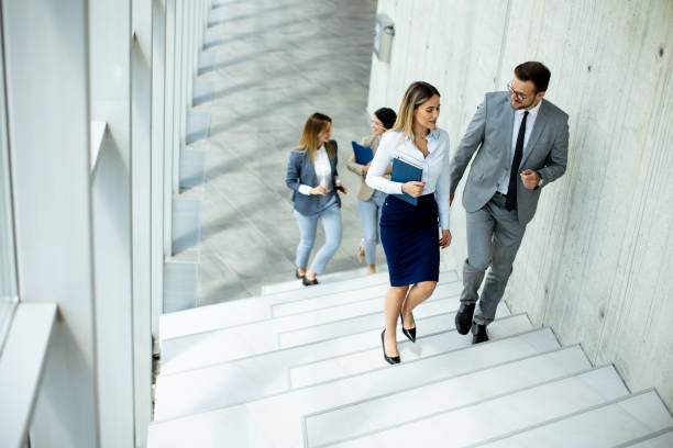 istock Young startup team have a discussion while climbing on  stairs in the office corridor 1565958240
