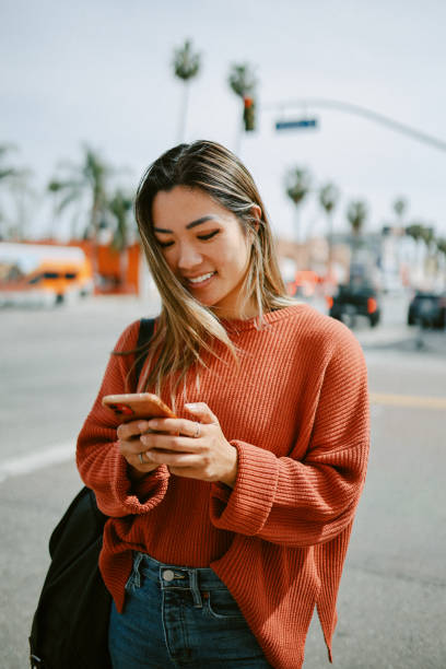 istock checking apps on the go in Los Angeles, California 1565965274