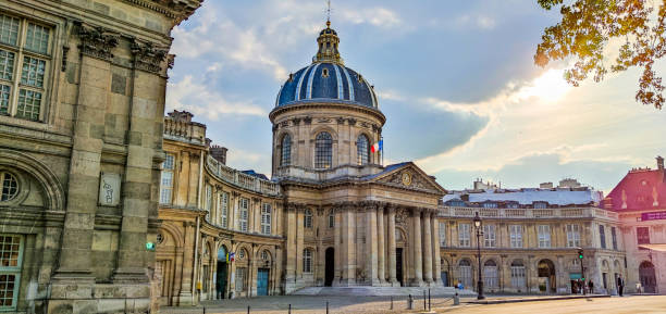 Parisian building of the Institut of France. Beautiful colours and a sunlight between the clouds.