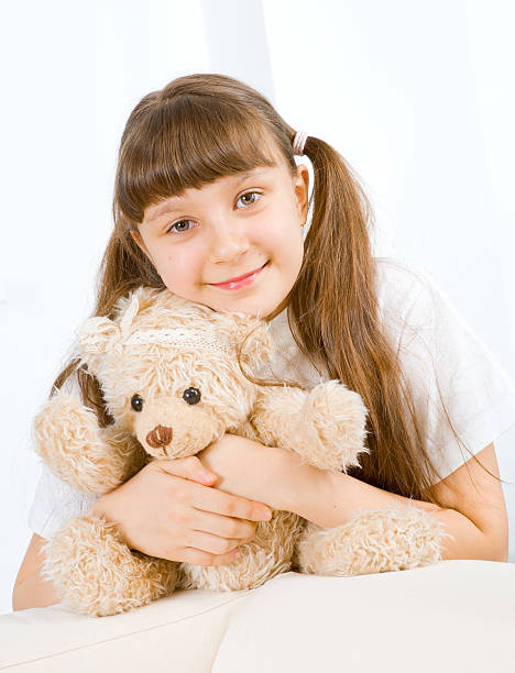 istock little girl with teddy bear 156596678