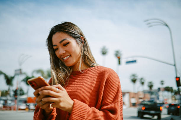 istock checking apps on the go in Los Angeles, California 1565968954