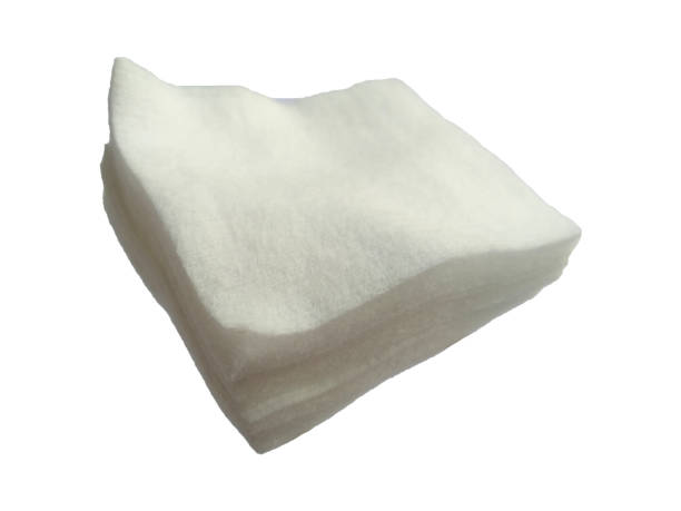 istock White cotton on white background. Cotton fiber texture background, white fluffy natural material. 1566022496