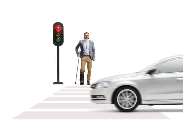 istock Man with a broken leg waiting at traffic lights 1566032057