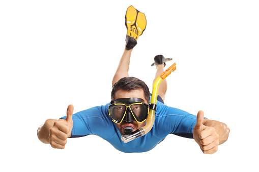 Man in a suit snorkeling with fins and a mask and gesturing thumbs up isolated on white background