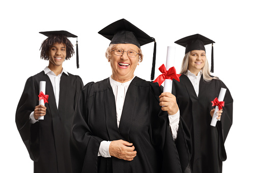 Graduate students and an elderly woman holding certificates and smiling isolated on white background