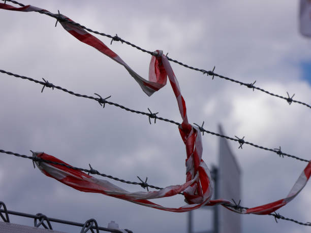 istock Close up of barbed wire against the sky 1566045655