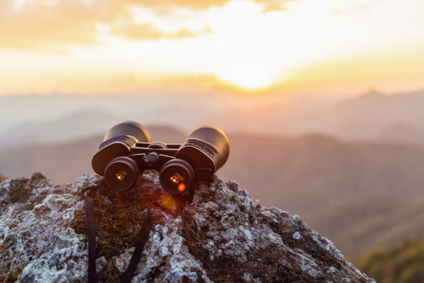 istock binoculars on top of rock mountain at sunset 1566048857