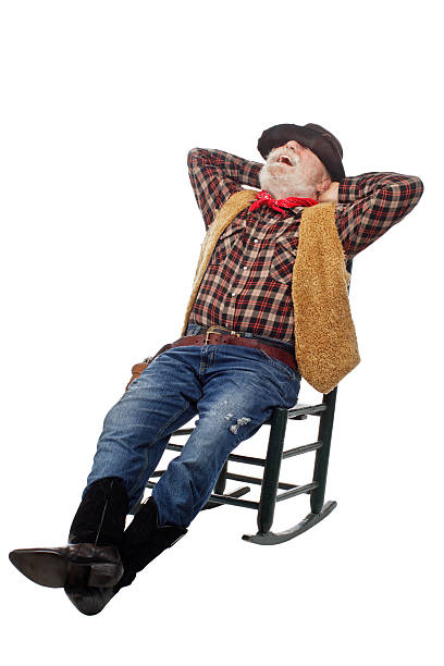 istock Laughing old cowboy leans back in rocking chair 156605914
