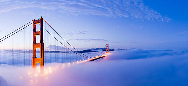 Golden Gate Bridge San Francisco USA The Golden Gate bridge in San Francisco surrounded by fog at twilight, USA. golden gate bridge stock pictures, royalty-free photos & images