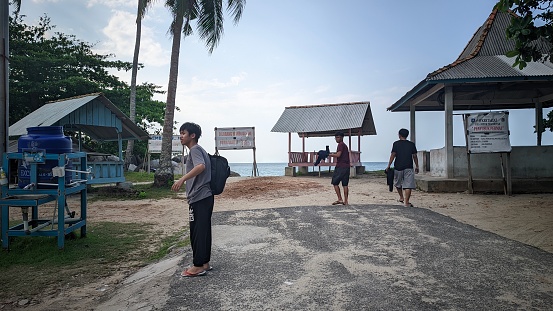 Bangka Belitung , Indonesia - 23 July 2023 :Summer Recreation By Traveling to Penyusuk Beach, there are lots of green trees and small huts for the visitors