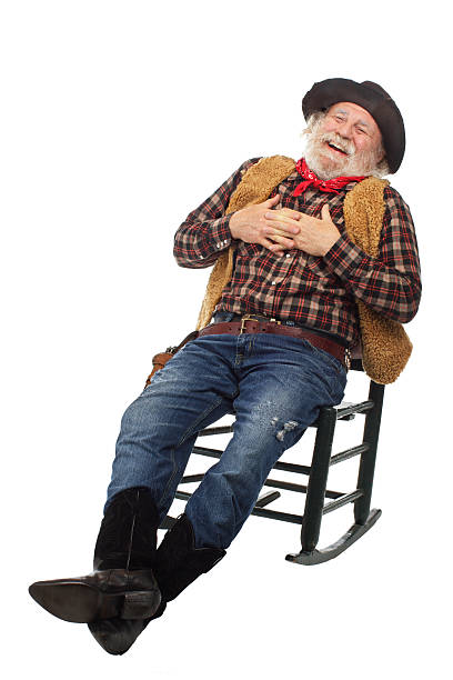istock Laughing old cowboy leans back in rocking chair 156607307