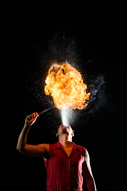 istock Street Performer Fire Breather Blowing on Torch 156608292