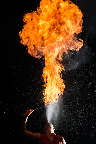 istock Street Performer Fire Breather Blowing on Torch 156608307