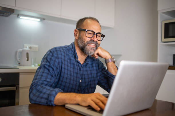 istock Mid adult man working from home 1566092459