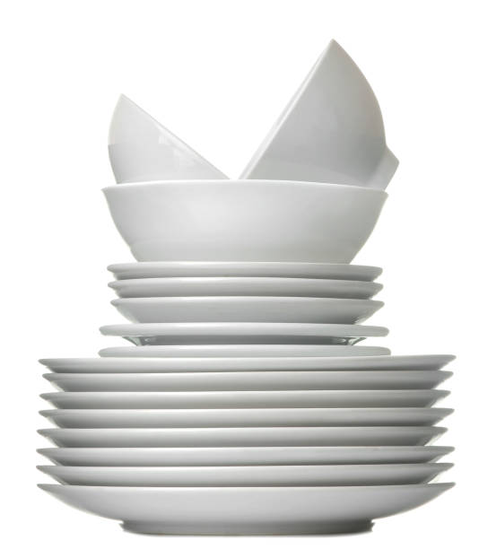 istock A stack of white ceramic dishes, plates, saucers, cups on a white isolated background 1566110506