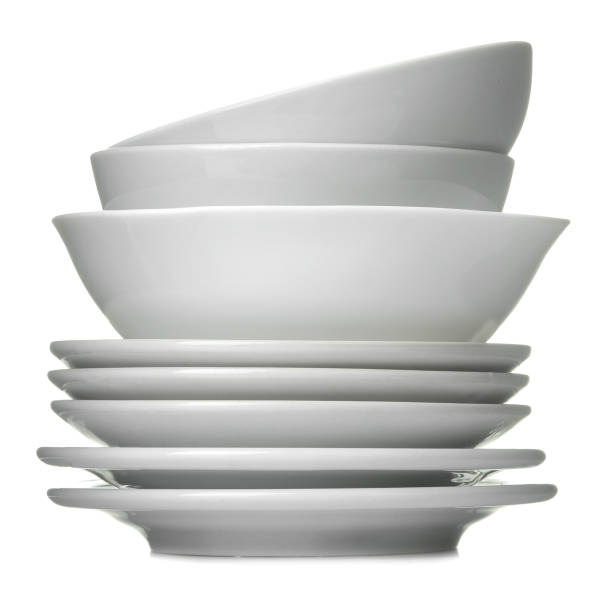 istock A stack of white ceramic dishes, plates, saucers, cups on a white isolated background 1566111022