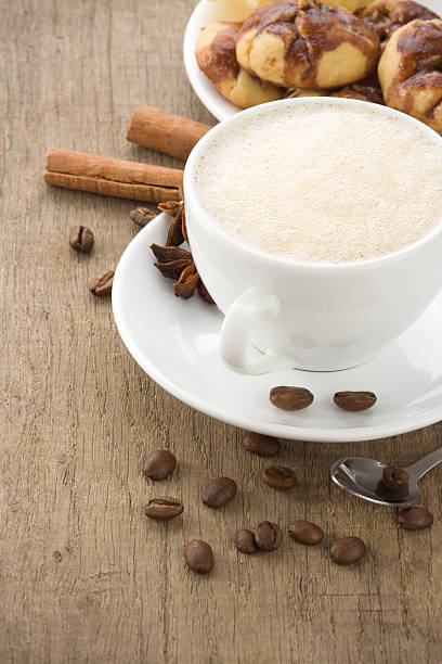 istock cup of coffee with beans on wood 156612169