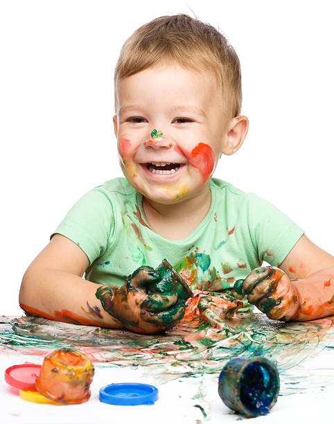 istock Child is grabbing some paint using fingers 156612562