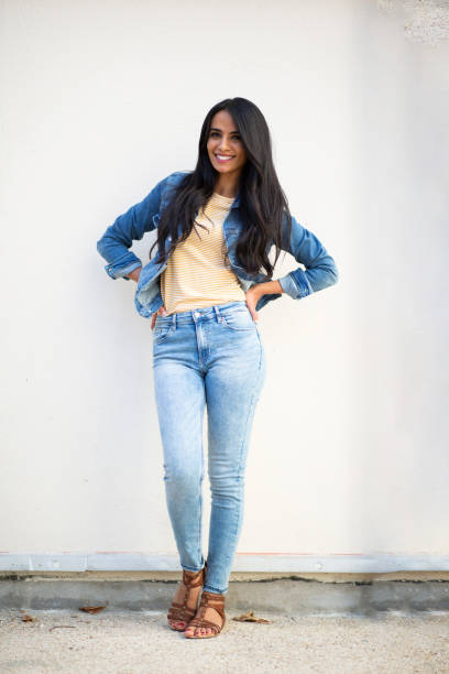 istock Attractive female model posing by white wall 1566129515